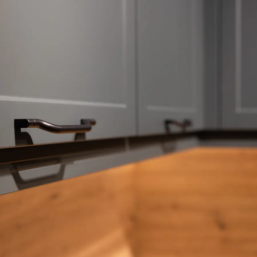 Dark cabinet fronts with modern hardware detail